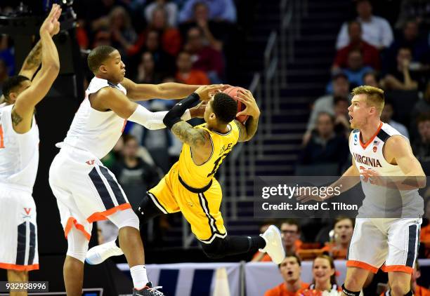 Devon Hall of the Virginia Cavaliers battles for possession with Jairus Lyles of the UMBC Retrievers during the first round of the 2018 NCAA Men's...