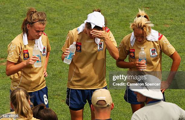 Jets players rehydrate during a compulsary drinks break due to extreme temperatures during the round eight W-League match between the Newcastle Jets...