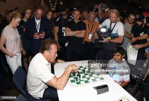 Arnold Schwarzenegger plays chess with Sharath Thandi during the Arnold Sports Festival Australia at The Melbourne Convention and Exhibition Centre...