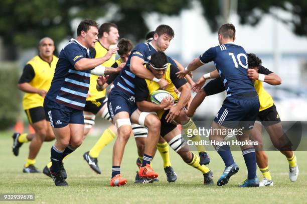Reed Prinsep of the Hurricanes is tackled by Jacob Pierce of the Blues A Team during the development squad trial match between the Hurricanes and the...