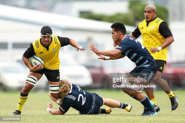 Reed Prinsep of the Hurricanes is tackled by Scott Gregory of the Blues A Team during the development squad trial match between the Hurricanes and...