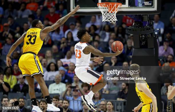 Nigel Johnson of the Virginia Cavaliers shoots against Arkel Lamar of the UMBC Retrievers during the first round of the 2018 NCAA Men's Basketball...