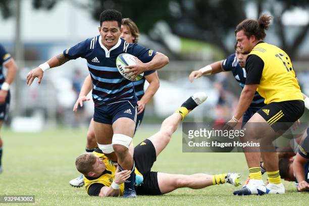 Sione Havili of the Blues A Team is tackled by James O'Rielly of the Hurricanes during the development squad trial match between the Hurricanes and...