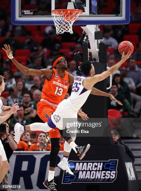 Alex Robinson of the TCU Horned Frogs drives to the basket against Paschal Chukwu of the Syracuse Orange during the first half in the first round of...