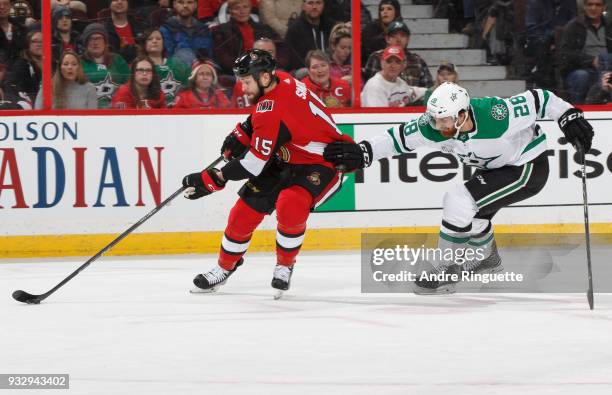 Zack Smith of the Ottawa Senators skates by Stephen Johns of the Dallas Stars with the puck at Canadian Tire Centre on March 16, 2018 in Ottawa,...