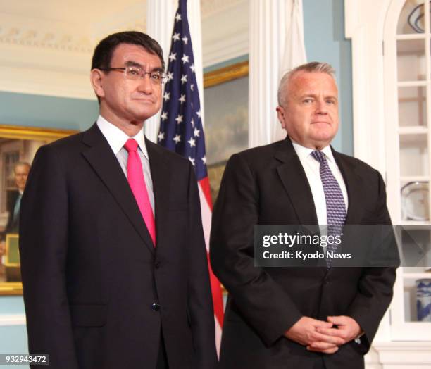 Japanese Foreign Minister Taro Kono poses for a commemorative photograph with United States Deputy Secretary of State John Sullivan in Washington on...