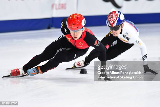 Tianyu Han of China competes against Yi Ra Seo of Korea in the men's 1500 meter heats during the World Short Track Speed Skating Championships at...