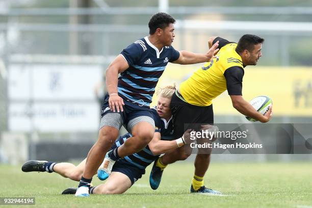 Chase Tiatia of the Hurricanes is tackled during the development squad trial match between the Hurricanes and the Blues at Evans Bay Park on March...