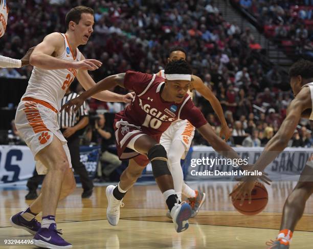 Jemerrio Jones of the New Mexico State Aggies fights for the ball against David Skara of the Clemson Tigers in the first half in the first round of...