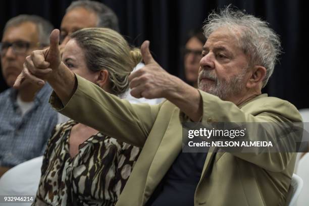 Brazilian former president Luiz Inacio Lula da Silva gestures next to Brazilian senator and president of the Workers Party Gleisi Hoffmann, during...