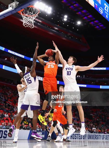 Tyus Battle of the Syracuse Orange drives to the basket against JD Miller and Vladimir Brodziansky of the TCU Horned Frogs during the first half in...