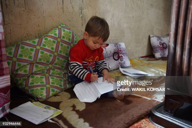 This picture taken on March 16, 2018 shows Afghan toddler Donald Trump, who is aged around 18 months, playing at his home in Kabul. Donald Trump...