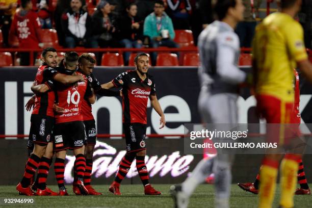 Tijuana's Miller Bolanos celebrates with teammates after scoring against Morelia during their Mexican Clausura 2018 tournament football match at the...