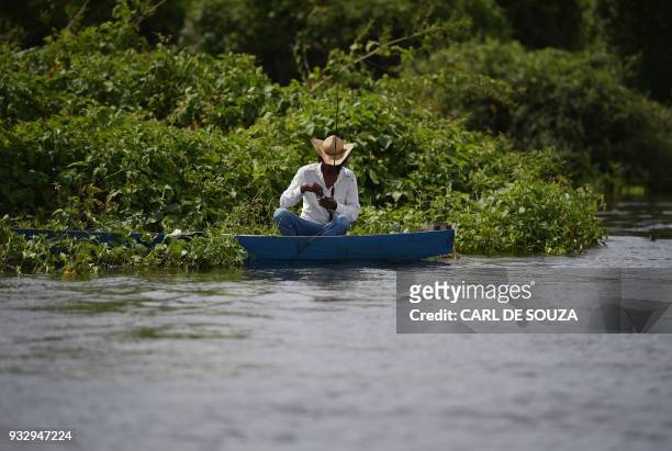Fisherman prepares his fishing reel at the Pantanal wetlands, in Mato Grosso state, Brazil on March 6, 2018. The Pantanal is the largest wetland on...
