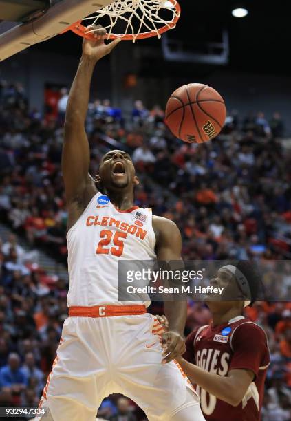 Aamir Simms of the Clemson Tigers dunks against Jemerrio Jones of the New Mexico State Aggies in the first half in the first round of the 2018 NCAA...