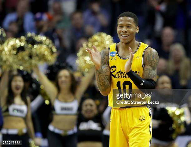 Jairus Lyles of the UMBC Retrievers reacts to their upset of the Virginia Cavaliers 74-54 during the first round of the 2018 NCAA Men's Basketball...