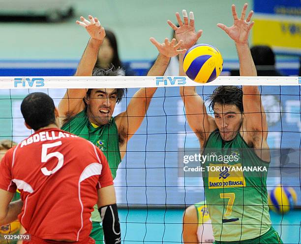 Gilberto Godoy Filho and Lucas Saatkamp of Brazil block a ball from Abdel Latif Ahmed of Egypt during their match at the men's Grand Championship Cup...