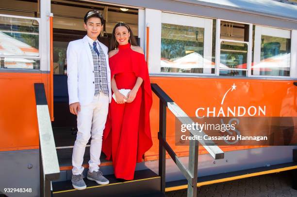 Kevin Kim and Chloe Esposito pose at the Chandon Tram at Chandon S Ladies Day at Rosehill Gardens on March 17, 2018 in Sydney, Australia.