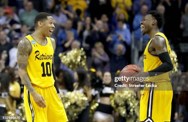 Jairus Lyles and teammate Jourdan Grant of the UMBC Retrievers react to their 74-54 victory over the Virginia Cavaliers during the first round of the...