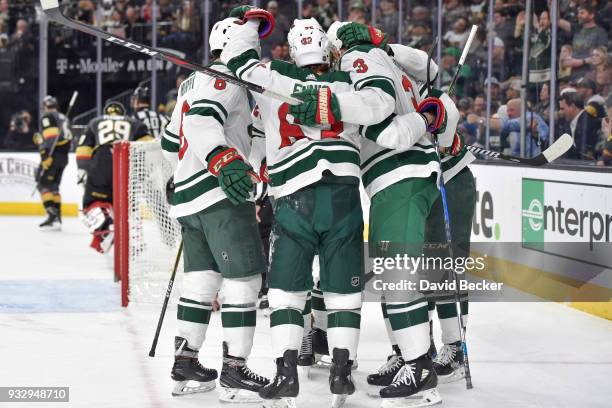 Charlie Coyle celebrates his goal with teammates Ryan Murphy, Tyler Ennis and Jonas Brodin of the Minnesota Wild against the Vegas Golden Knights...