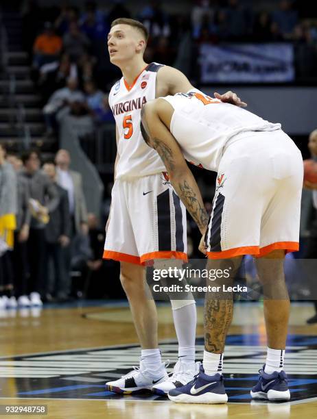 Kyle Guy and teammate Isaiah Wilkins of the Virginia Cavaliers react to their 74-54 loss to the UMBC Retrievers during the first round of the 2018...