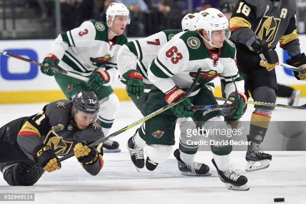 Tyler Ennis of the Minnesota Wild skates to the puck with William Karlsson of the Vegas Golden Knights defending during the game at T-Mobile Arena on...