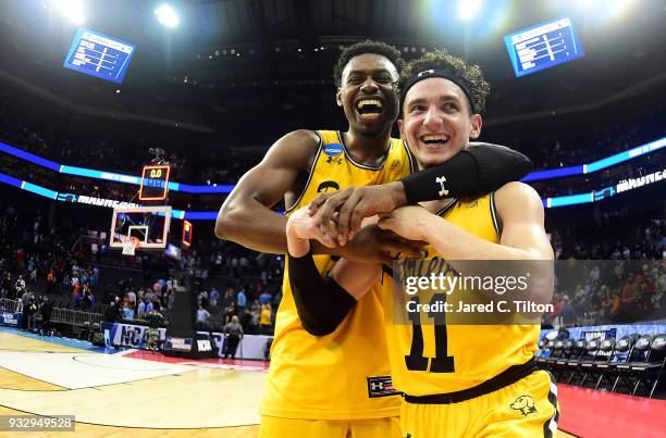 Maura and teammate Jourdan Grant of the UMBC Retrievers celebrate their 74-54 victory over the Virginia Cavaliers during the first round of the 2018...