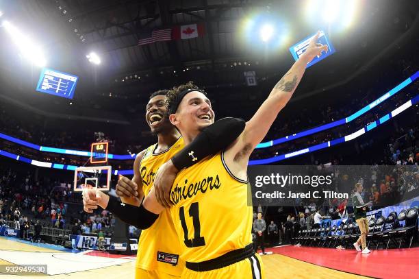 Maura and teammate Jourdan Grant of the UMBC Retrievers celebrate their 74-54 victory over the Virginia Cavaliers during the first round of the 2018...