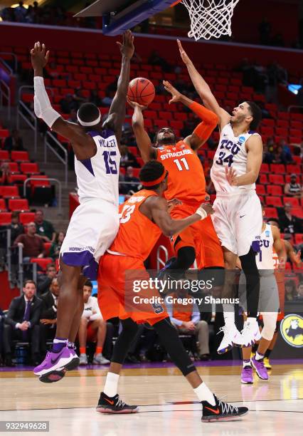 Oshae Brissett of the Syracuse Orange shoots the ball against Kenrich Williams and JD Miller of the TCU Horned Frogs during the second half in the...