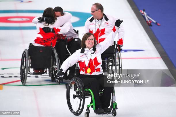 Canada's team celebrate their victory in the wheelchair curling bronze medal game between South Korea and Canada at the Gangneung Curling Centre...
