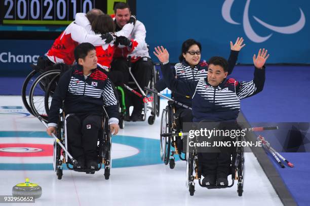 South Korea's team waves to the crowd after losing the wheelchair curling bronze medal game to Canada at the Gangneung Curling Centre during the...