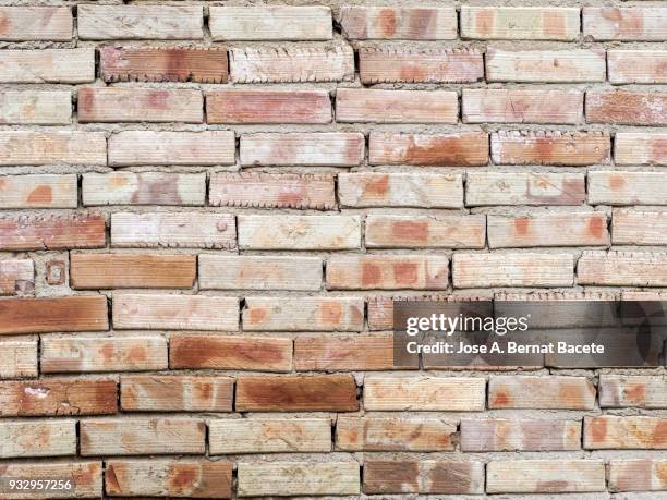 full frame of a facade of a wall with bricks . high resolution photography. - adobe wall fotografías e imágenes de stock