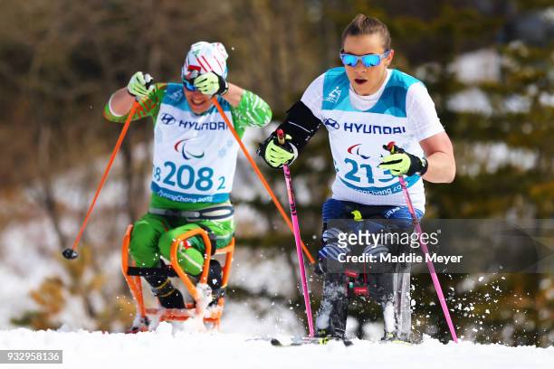 Oksana Masters of the United States passes Liudmila Vauchok of Belarus during the Women's 5 km Sitting Classic at Alpensia Biathlon Centre on Day 8...