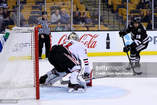 Providence Friars forward Scott Conway takes a shot against Northeastern Huskies goaltender Cayden Primeau during a college hockey game between...