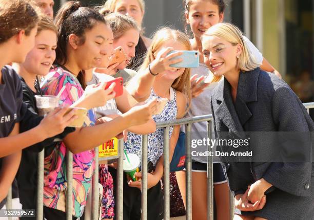 Margot Robbie poses for a photo with a fan during the Peter Rabbit Australian Premiere on March 17, 2018 in Sydney, Australia.