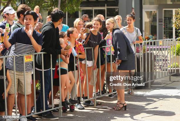 Margot Robbie poses for a photo with fans during the Peter Rabbit Australian Premiere on March 17, 2018 in Sydney, Australia.