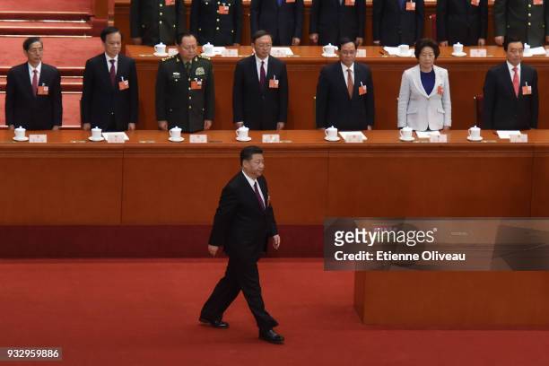 Chinese President Xi Jinping walks to a podium to swear under oath after being elected for a second five-year term during the 5th plenary session of...