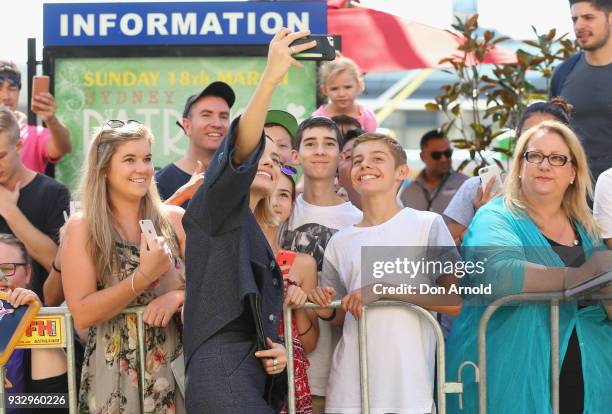 Margot Robbie poses for a photo with a fan during the Peter Rabbit Australian Premiere on March 17, 2018 in Sydney, Australia.