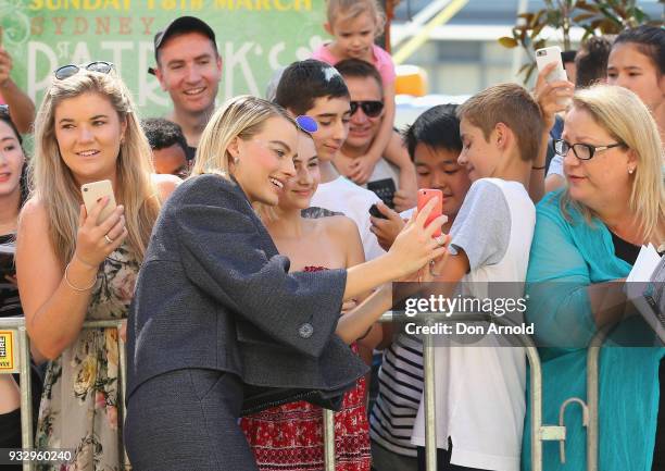 Margot Robbie poses for a photo with a fan during the Peter Rabbit Australian Premiere on March 17, 2018 in Sydney, Australia.