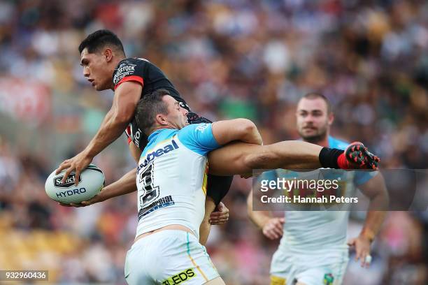 Roger Tuivasa-Sheck of the Warriors is tackled by Michael Gordon of the Titans during the round two NRL match between the New Zealand Warriors and...