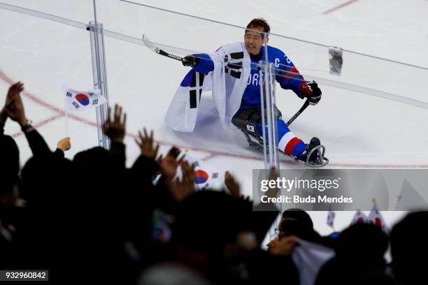 Min Su Han of Korea celebrates with the crowd after winning the bronze medal against Italy the Ice Hockey bronze medal game between Korea and Italy...