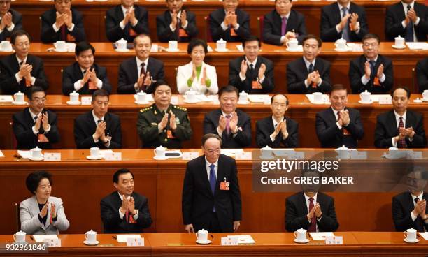 Wang Qishan , China's newly elected Vice President, receives applause after being elected during the fifth plenary session of the first session of...