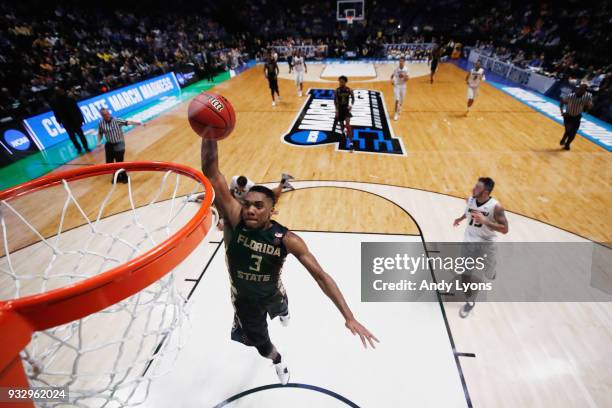 Trent Forrest of the Florida State Seminoles dunks the ball against the Missouri Tigers during the game in the first round of the 2018 NCAA Men's...