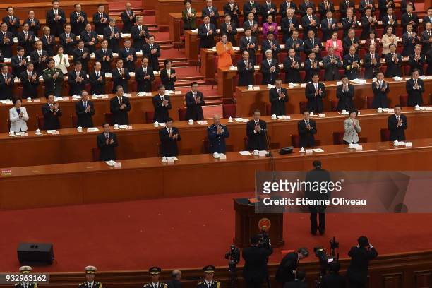 Chinese President Xi Jinping bows after swearing under oath after being being elected for a second five-year term during the 5th plenary session of...