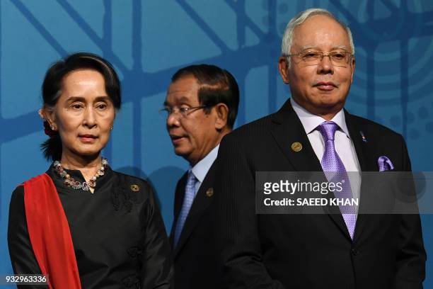 Cambodia's Prime Minister Hun Sen makes his way for a family picture as Malaysia's Prime Minister Najib Razak and Myanmar's State Counsellor Aung San...