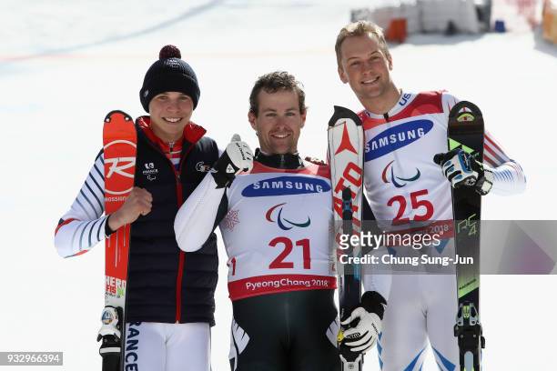 Silver medalist Arthur Bauchet of France, gold medalist Adam Hall of New Zealand and bronze medalist Jamie Stanton of the United States celerbate...