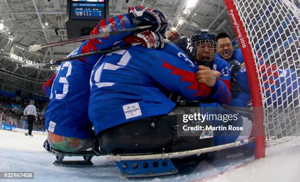 Jon Ho Jang of Korea celebrate with his team mates after winning the bronze medal over Italy in the Ice Hockey bronze medal game between Korea and...