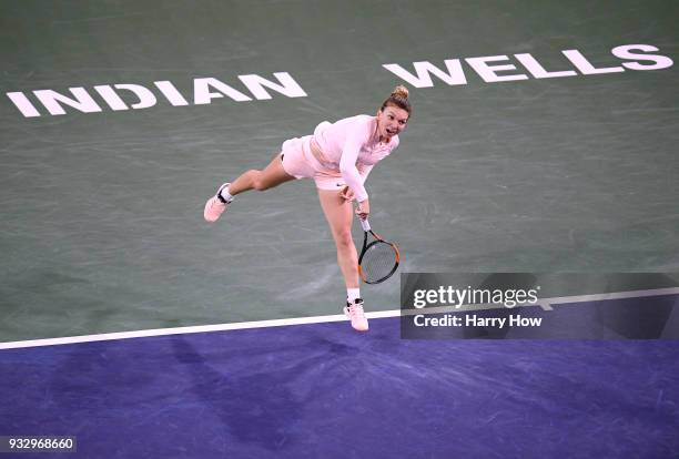 Simona Halep of Romania serves to Naomi Osaka of Japan in a semifinal during the BNP Paribas Open at the Indian Wells Tennis Garden on March 16, 2018...
