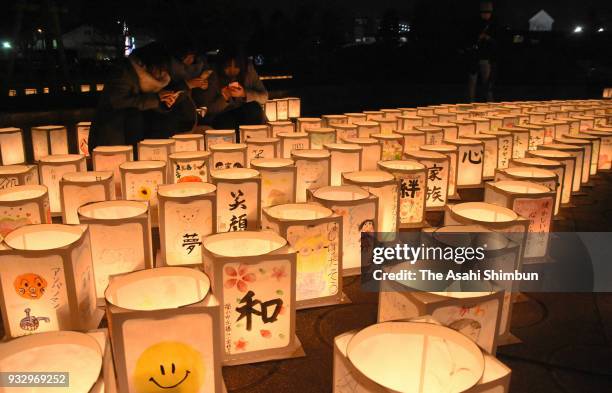 Candle lit lanterns are seen to commemorate the victims on the 7th anniversary of the Great East Japan Earthquake on March 11, 2018 in Natori,...