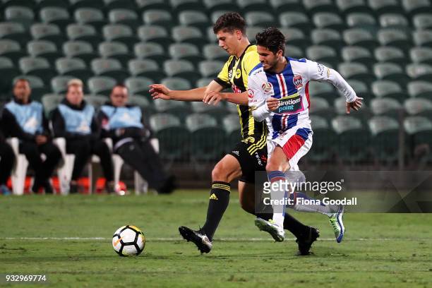 Patricio Rodriguez of the Newcastle Jets tackles Liberato Cacace of the Wellington Phoenix during the round 23 A-League match between the Wellington...